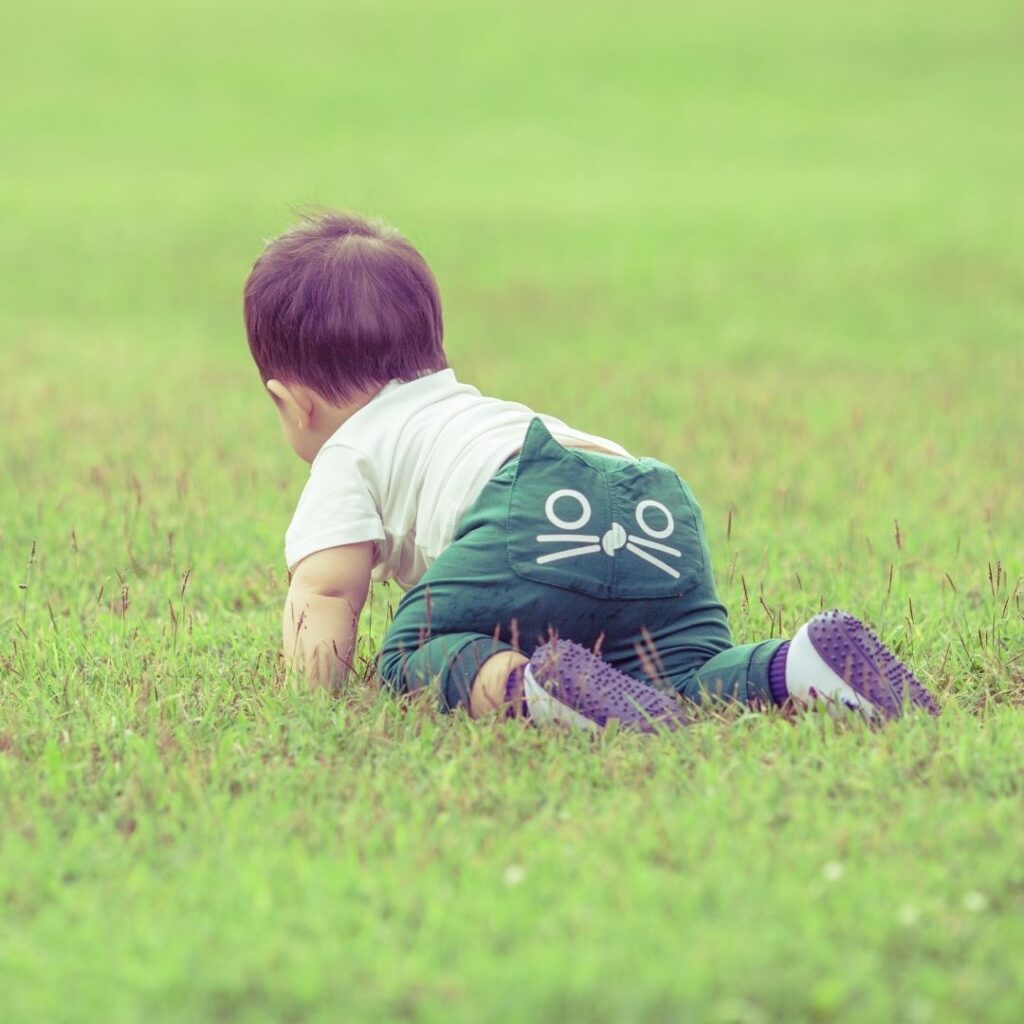 Baby crawling on grass
